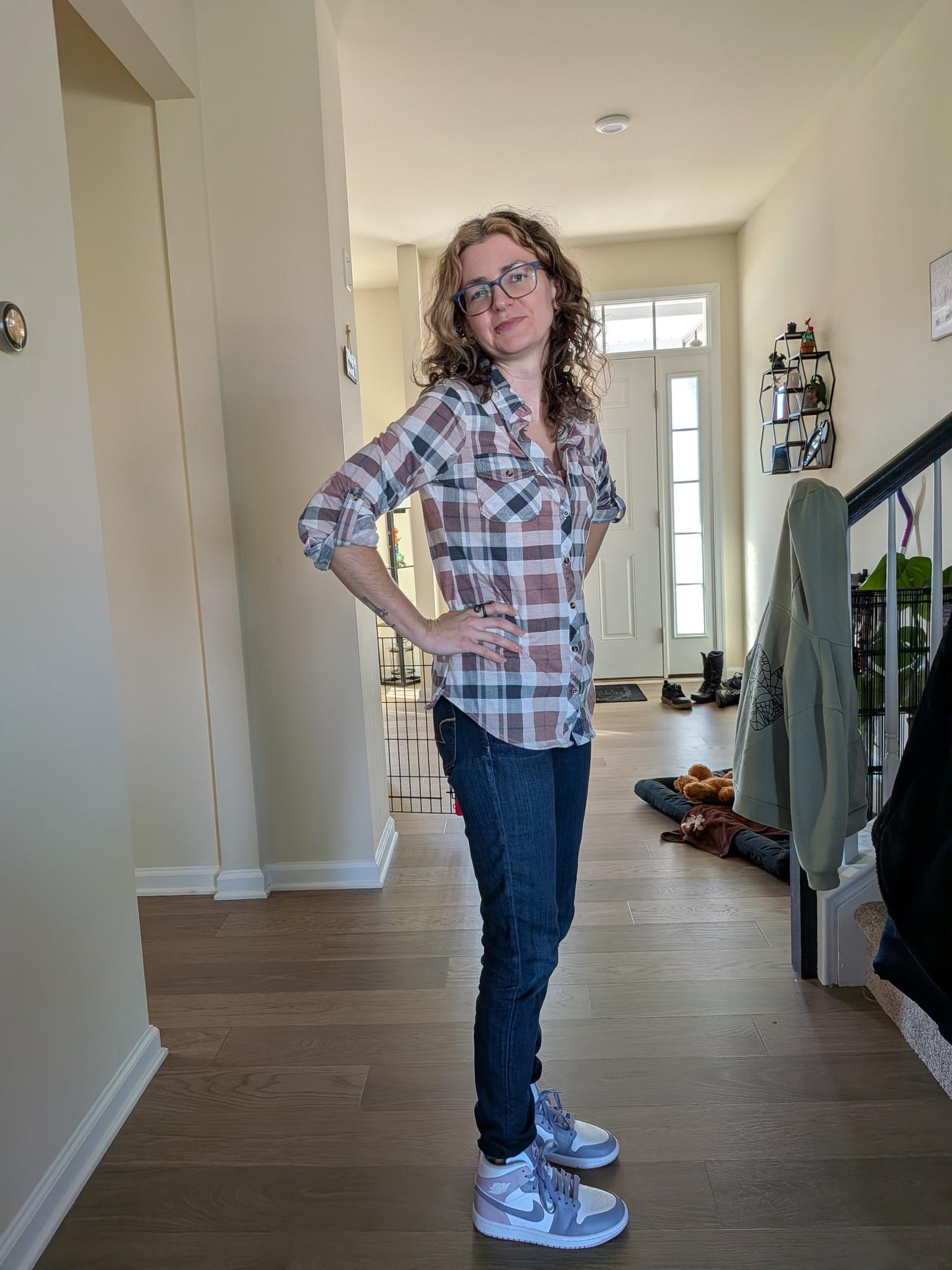 Ariana, owner of Solnoir Plant Co., standing at home